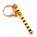 yellow smile keychain on a white background